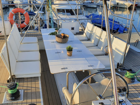 A spacious and well-appointed dining area on a yacht, featuring comfortable seating and a helm, perfect for gatherings and enjoying meals on the water.