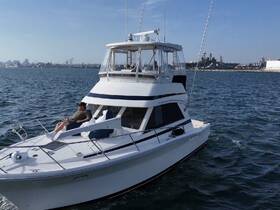 A man relaxes on the deck of a yacht while cruising on calm waters, showcasing the perfect getaway for leisure and enjoyment.