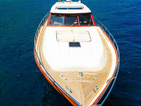 A stunning aerial view of a luxurious yacht cruising through clear blue waters, showcasing its elegant design and craftsmanship.