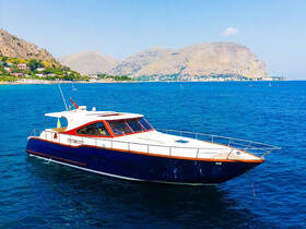 A stunning yacht cruising through clear blue waters, with picturesque mountains and a coastal village in the background — perfect for luxury charters and scenic tours.