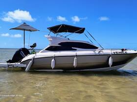 A sleek yacht named 'Venice' is docked in shallow waters under a clear blue sky, showcasing its elegant design and perfect for leisurely outings.
