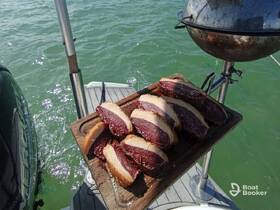 A beautifully arranged platter of grilled meat sits on a boat, showcasing the perfect setup for a delicious meal on the water.