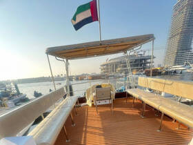Interior view of a spacious boat seating area, showcasing comfortable benches and a relaxing atmosphere, perfect for enjoying time on the water.