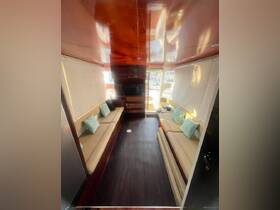 Interior view of a spacious boat cabin featuring comfortable seating and modern amenities, perfect for relaxing during a day on the water.
