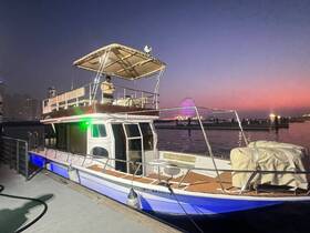 A beautifully lit boat docked at sunset, showcasing its elegant design against a vibrant sky — perfect for evening cruises and gatherings.