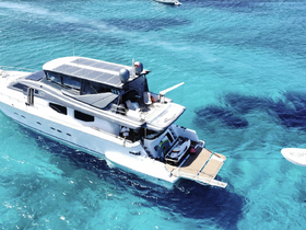 A stunning aerial view of a luxurious yacht cruising through crystal-clear turquoise waters, showcasing its sleek design and modern features.