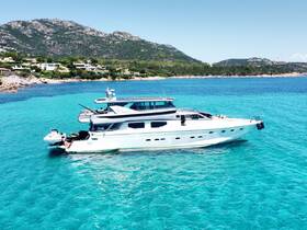 An aerial view of a luxurious yacht docked in crystal-clear waters, surrounded by stunning coastal scenery — perfect for summer getaways and private charters.