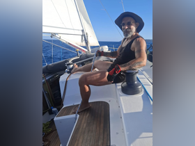 A man enjoys sailing on a yacht, showcasing the thrill of being out on the open ocean. Perfect for adventure seekers and sailing enthusiasts.