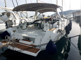 A detailed view of the helm and interior of a sleek sailboat, showcasing the modern console and spacious layout, perfect for comfortable sailing experiences.