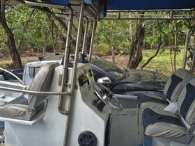 Interior view of a boat's helm and seating area, showcasing the comfortable setup for navigation and relaxation.