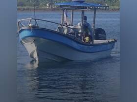 A speedboat navigates through calm waters, showcasing its sleek design and functionality — perfect for fishing trips or coastal exploration.