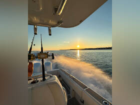 A stunning sunset view from a boat, showcasing the excitement of fishing on the water as the sun sets on the horizon.