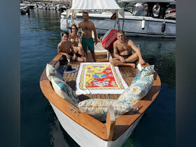 A cheerful group enjoys a sunny day on a boat, showcasing a perfect setting for family fun and relaxation on the water.