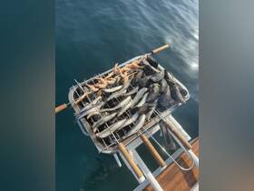 A delicious assortment of seafood grilling on a boat, featuring shrimp and fish, perfect for a gourmet experience on the water.