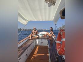 A couple enjoys a relaxing day on a boat, soaking up the sun and the beautiful ocean views — perfect for a romantic getaway or a day of leisure on the water.