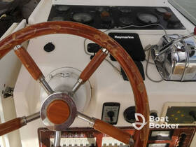 A close-up view of the helm and control console of a boat, showcasing the steering wheel and various instruments — ideal for those interested in boating mechanics and navigation.
