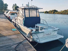 A well-maintained boat named 'Cristina' docked at a marina, showcasing its sleek hull and tranquil surroundings.