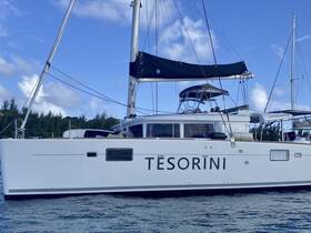 A stunning side view of the catamaran 'Tesorini' docked in calm waters, showcasing its sleek design and spacious layout, perfect for luxury sailing adventures.