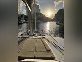 A serene view from the deck of a yacht at sunset, showcasing the tranquil waters and surrounding marina — perfect for evening cruises.