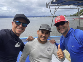 Three crew members pose for a cheerful selfie aboard their boat, showcasing camaraderie and the spirit of adventure on the water.