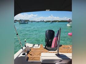 A view from the helm of a boat, showcasing the console and the vibrant turquoise waters ahead, perfect for a day of adventure on the water.