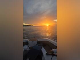 A stunning sunset view from the deck of a boat, showcasing the tranquil waters and vibrant colors of the evening sky — perfect for romantic cruises or peaceful retreats on the water.