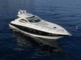 A sleek speedboat glides through calm waters, showcasing its elegant design and perfect for thrilling adventures on the open sea.