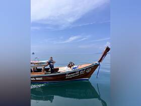 A couple enjoys a relaxing moment on a traditional boat during a scenic tour, surrounded by calm waters and a clear blue sky.