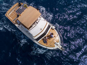 Aerial view of a family enjoying time on a yacht, with children playing on the deck — a perfect snapshot of fun and relaxation on the water.
