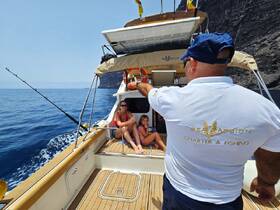 A family enjoys a fishing charter on a boat, with scenic views and a relaxed atmosphere, perfect for creating lasting memories on the water.