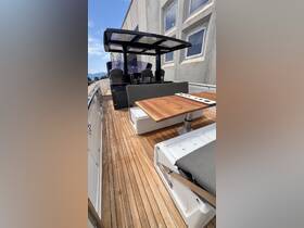 A spacious interior view of a modern boat's helm and seating area, showcasing elegant wood finishes and comfortable seating for an enjoyable boating experience.