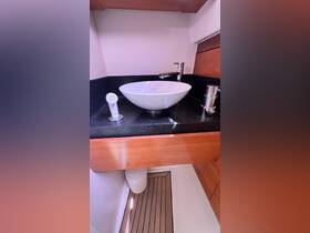 A sleek and modern bathroom sink area inside a boat, featuring elegant fixtures and a stylish design, perfect for onboard comfort.