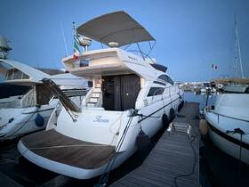 A sleek yacht named 'Seven' docked at a marina, showcasing its elegant design and surroundings under the evening sky.