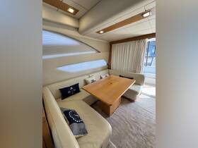 A cozy and stylish interior view of a boat's dining area, featuring comfortable seating and a wooden table, perfect for relaxing meals on the water.