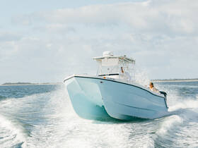 A sleek speedboat cuts through the water, showcasing an exhilarating ride on the open sea — perfect for adventure seekers.