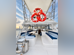 A spacious interior of a boat featuring comfortable seating and a well-equipped helm, perfect for relaxing and enjoying the journey on the water.