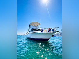 A stunning view of a yacht cruising through clear waters, showcasing its sleek design against a bright blue sky — perfect for luxury boating experiences.