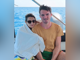 A couple enjoys a cozy moment on a boat, surrounded by the beautiful ocean — perfect for romantic getaways and memorable experiences on the water.