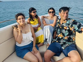 A joyful family enjoys their time on a boat, capturing smiles and laughter against a beautiful ocean backdrop — perfect for memorable outings and family adventures.