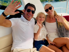 A cheerful family waves from the deck of a boat, capturing a joyful moment on the water — perfect for family outings and memorable adventures.