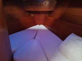 Cozy cabin interior featuring a comfortable sleeping area, perfect for relaxing on overnight boating trips.