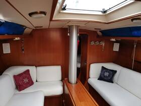 Interior view of a cozy boat cabin featuring comfortable seating and wooden finishes, perfect for relaxing during a sailing trip.