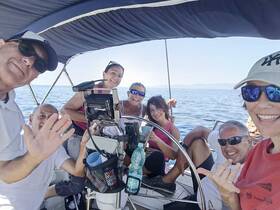 A cheerful group of friends enjoys a fun moment aboard a boat, capturing the essence of camaraderie and adventure on the water.