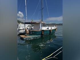 A beautifully docked boat named 'Micol' showcases its elegant design against a clear blue sky, perfect for leisurely outings on the water.