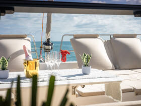 A beautifully set table on a yacht featuring a champagne bucket and elegant glasses, perfect for a luxurious day on the water.