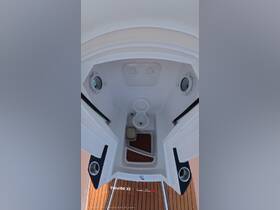 Interior view of a boat's bathroom, showcasing the toilet and wooden flooring — a functional space for comfort while at sea.
