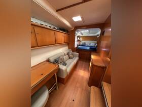 A cozy interior view of a boat cabin featuring comfortable seating and a lounge area, perfect for relaxing during your maritime adventures.