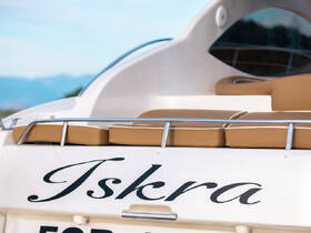 Close-up view of the back of a boat named 'Iskra', showcasing its sleek design and comfortable seating area, ideal for leisurely outings on the water.