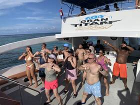 A lively group enjoys a boat party, dancing and celebrating under the sun — perfect for unforgettable moments on the water.
