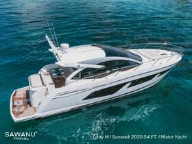 A stunning aerial view of the Lady M, a 2020 Sunseek 54 FT motor yacht, gliding through crystal-clear waters, showcasing its sleek design and luxurious features.